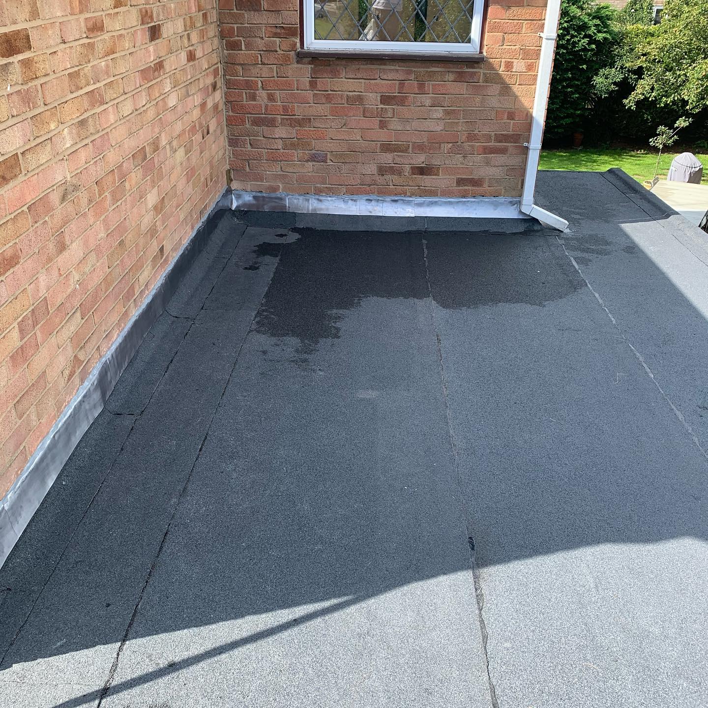 New torch-on felt flat roof with lead flashing