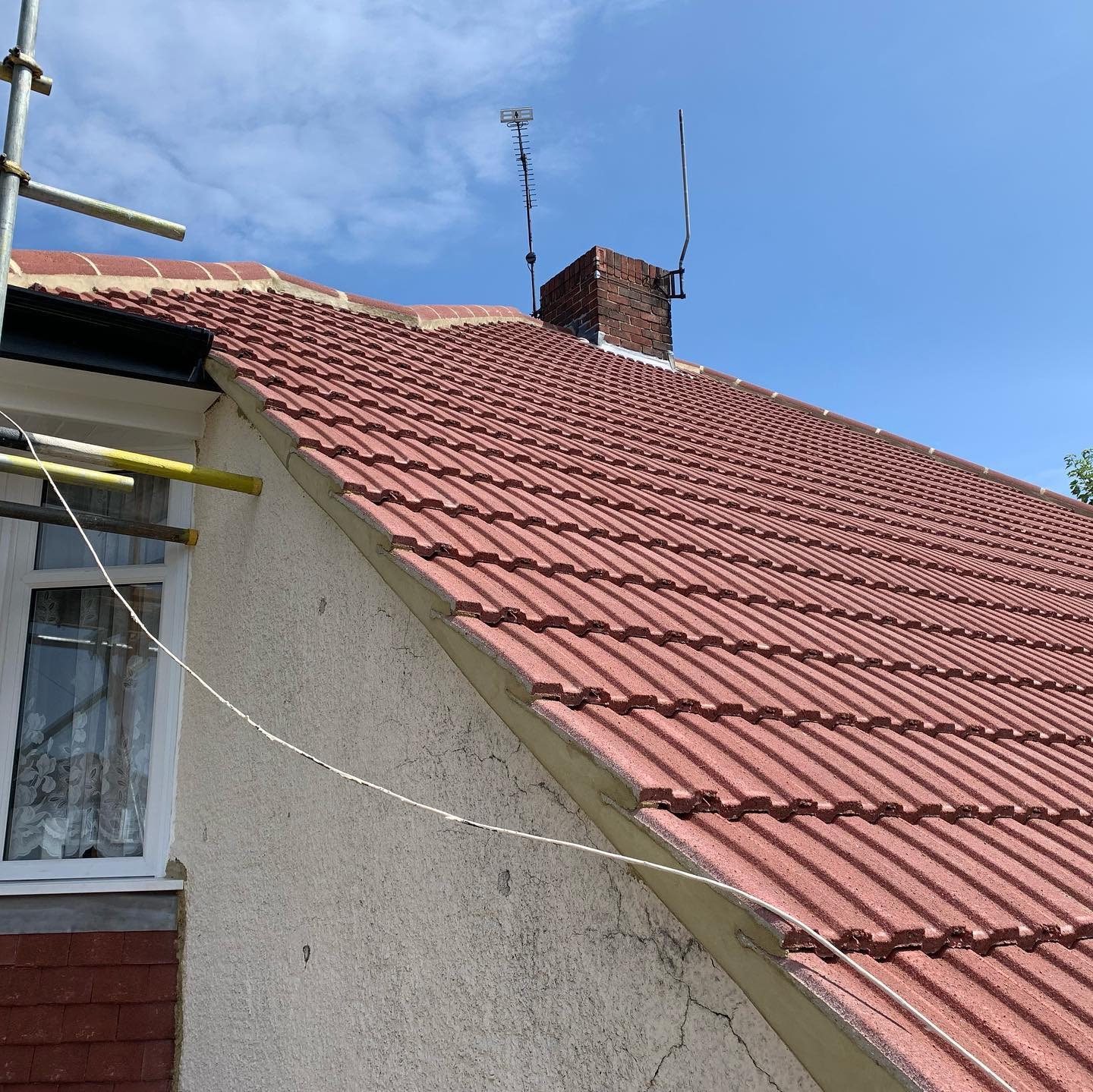 Finished red tile roof with new ridge