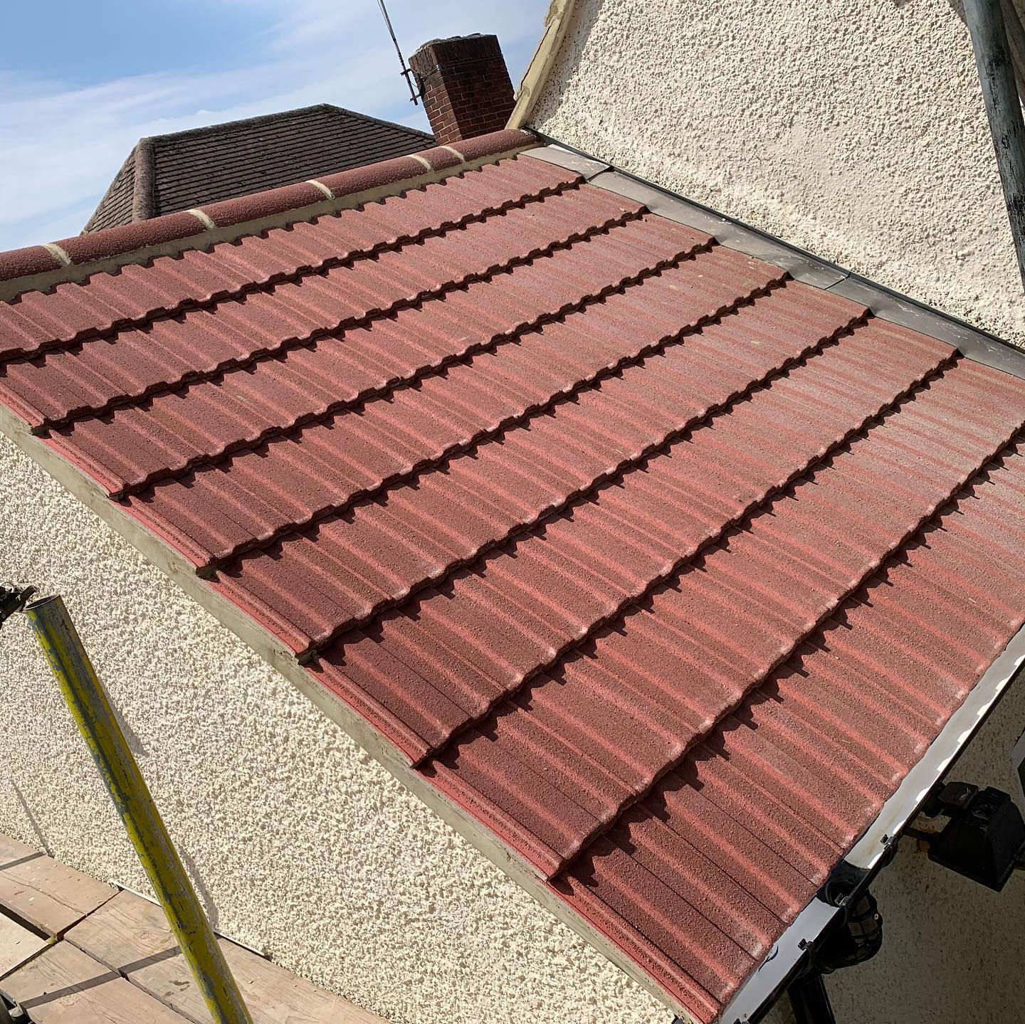 Newly tiled garage roof with ridge mortar bedded