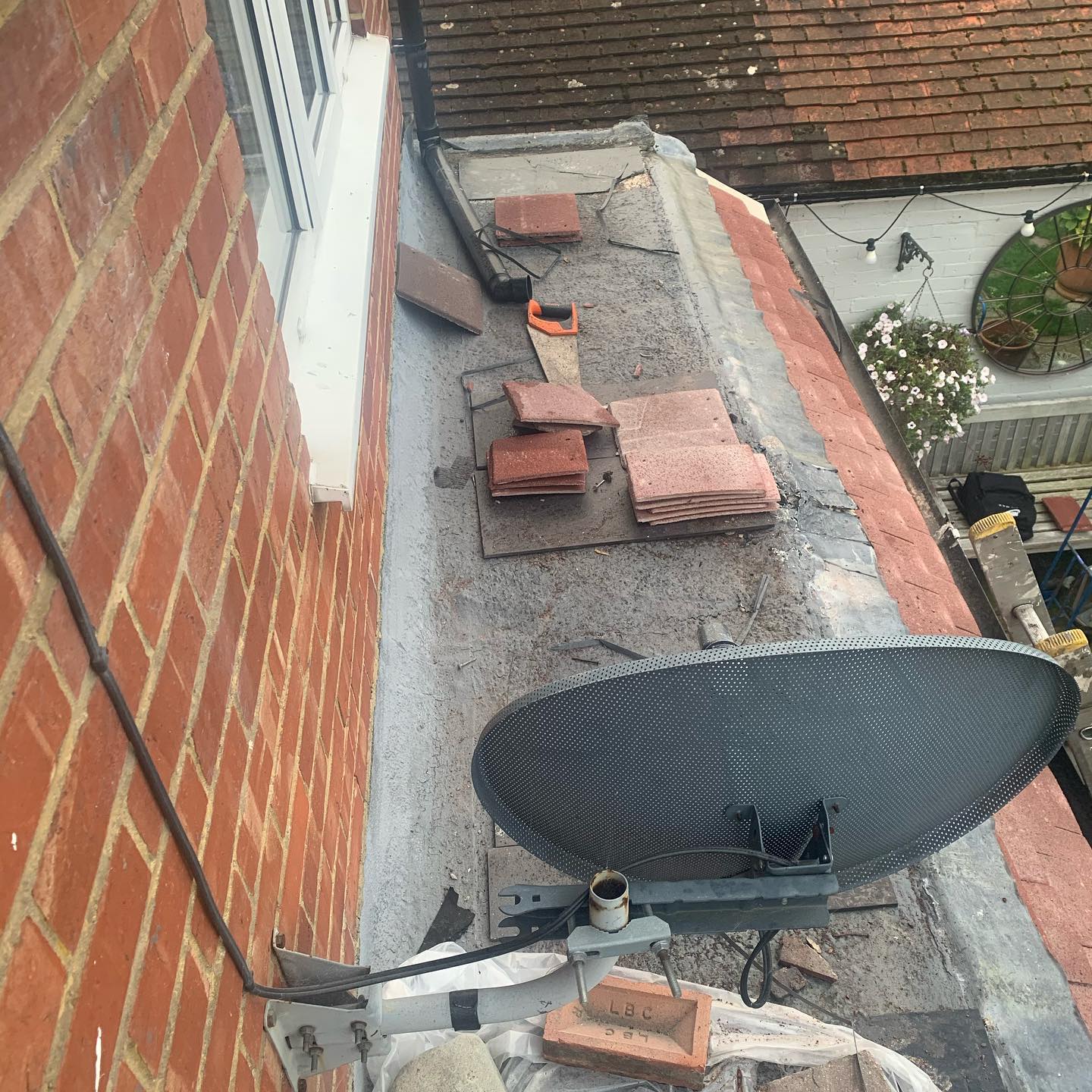 Flat roof tile preparation between properties